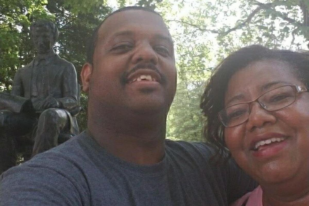 a man and a woman standing in front of a statue