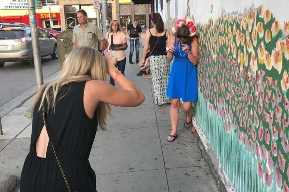 a woman taking a picture of a wall