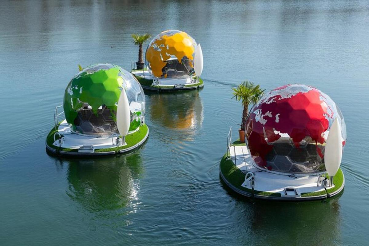 three balls in the water with palm trees in them