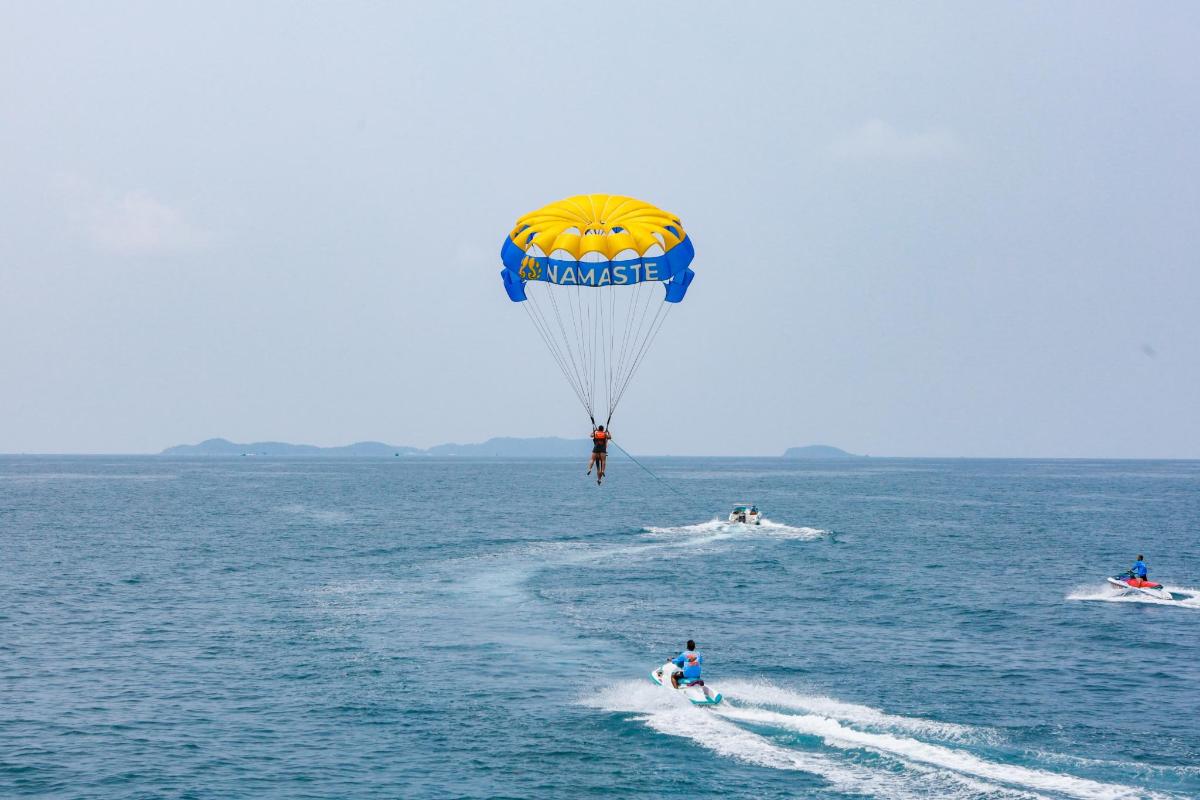 a person riding a parachute in the water