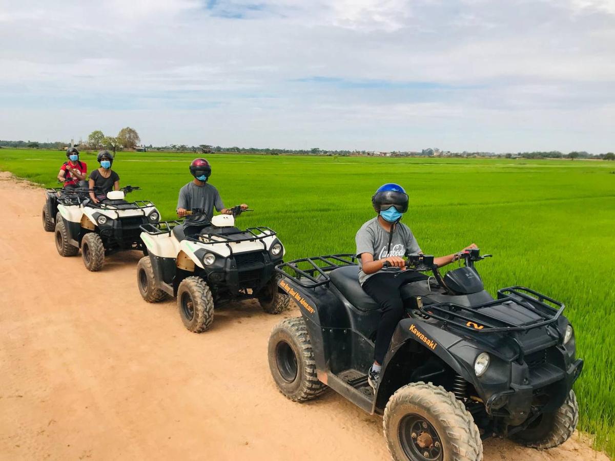 a group of people riding atvs on a dirt road