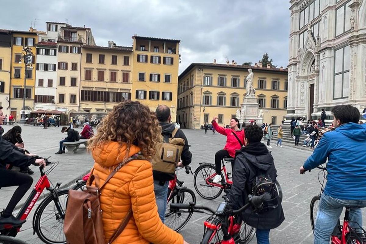 a group of people riding bikes on a city street