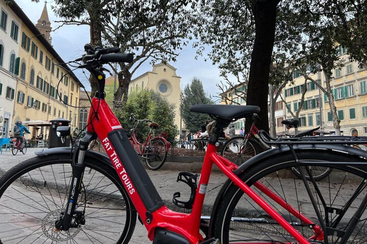 a red bike parked on a street next to buildings