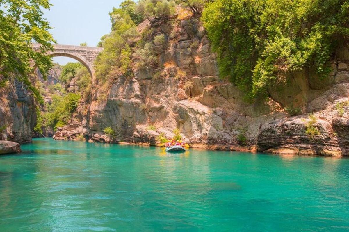 a boat in a river with a bridge in the background