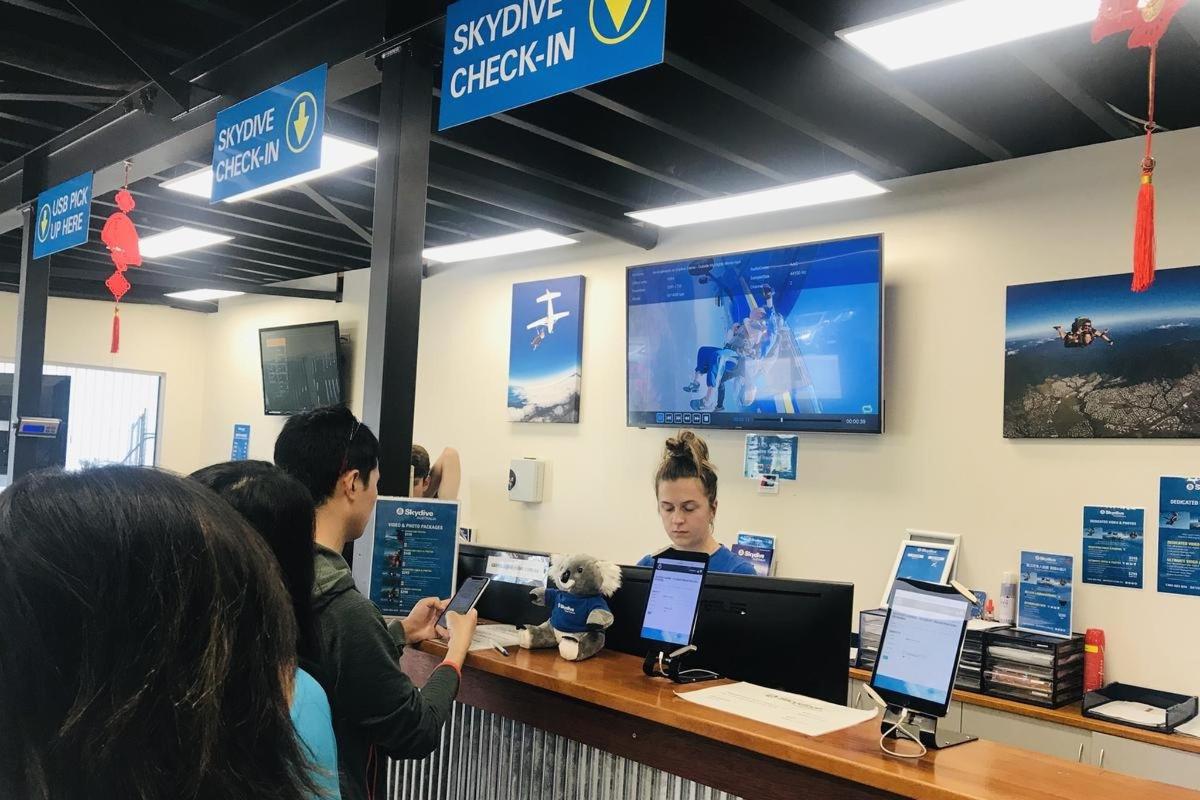 a group of people sitting at a counter with laptops