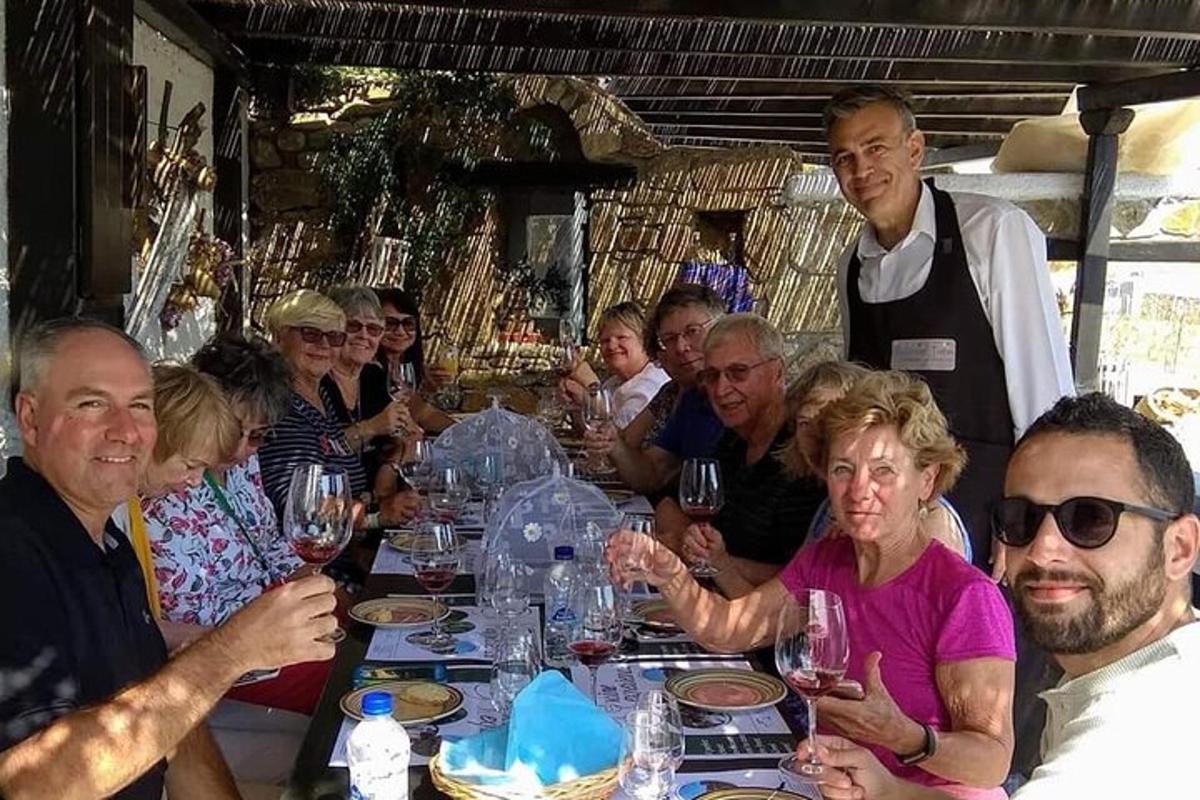 Un grupo de personas sentadas alrededor de una mesa con copas de vino.
