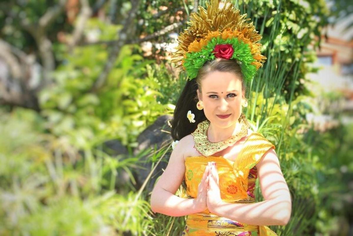a woman in an orange dress with a flower on her head