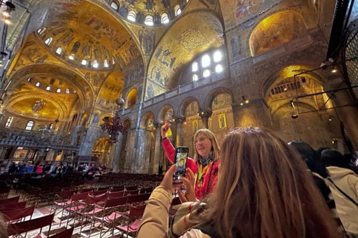 a woman holding up a cell phone in a large building