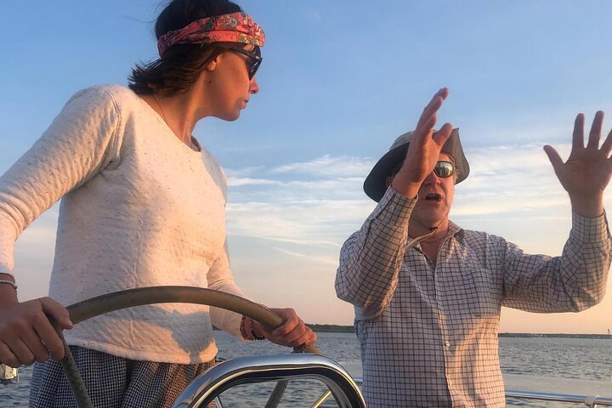 a man and a woman standing on a boat