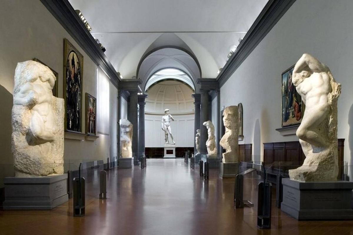 a museum with statues on display in a hallway