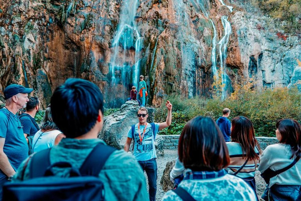 a crowd of people looking at a waterfall