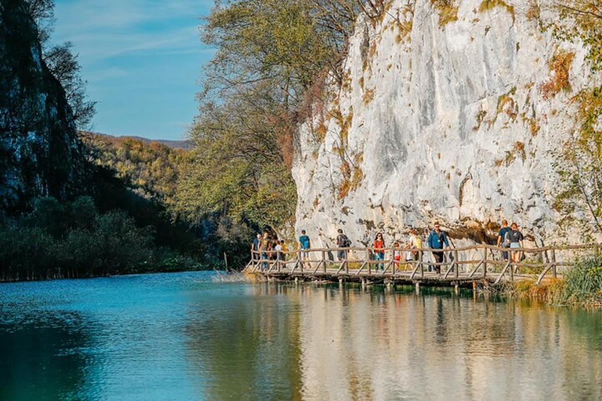 a group of people standing on a bridge over a river