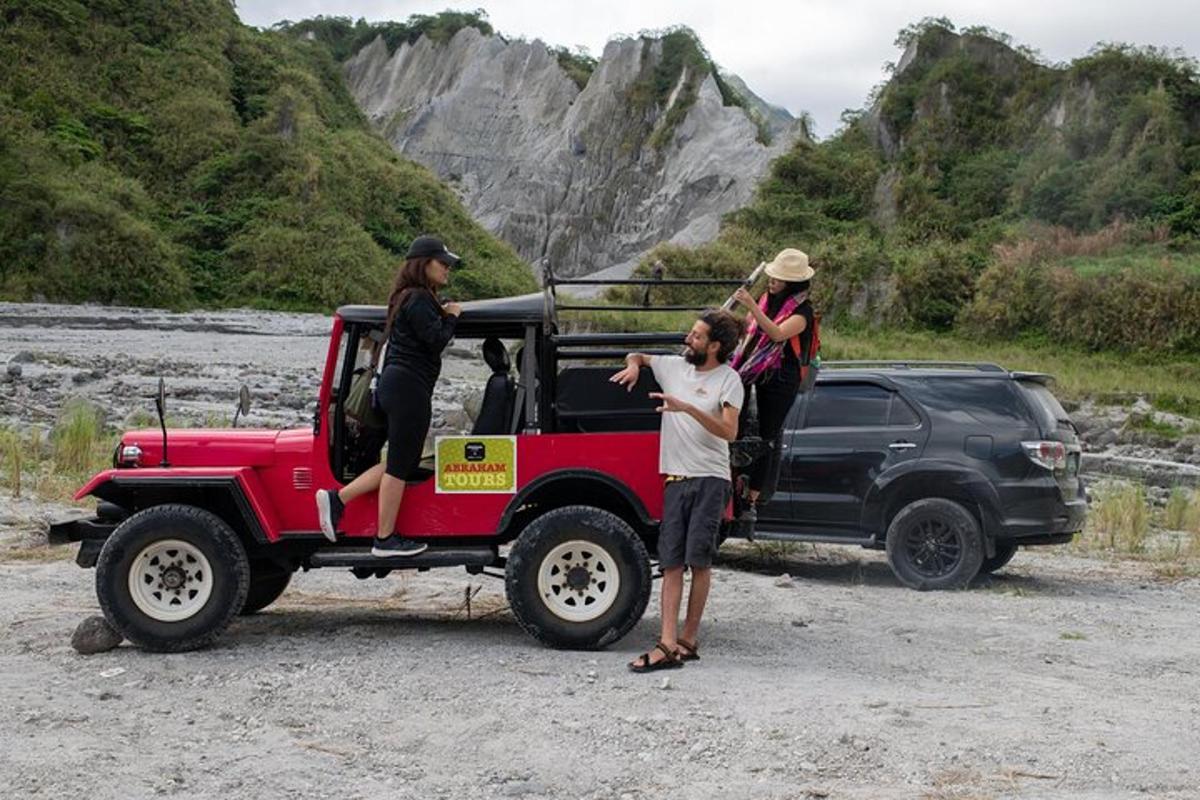 a group of people standing on the back of a jeep