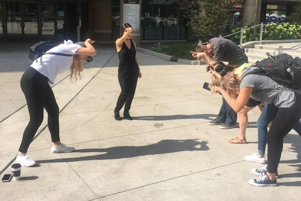 a group of people standing on a sidewalk