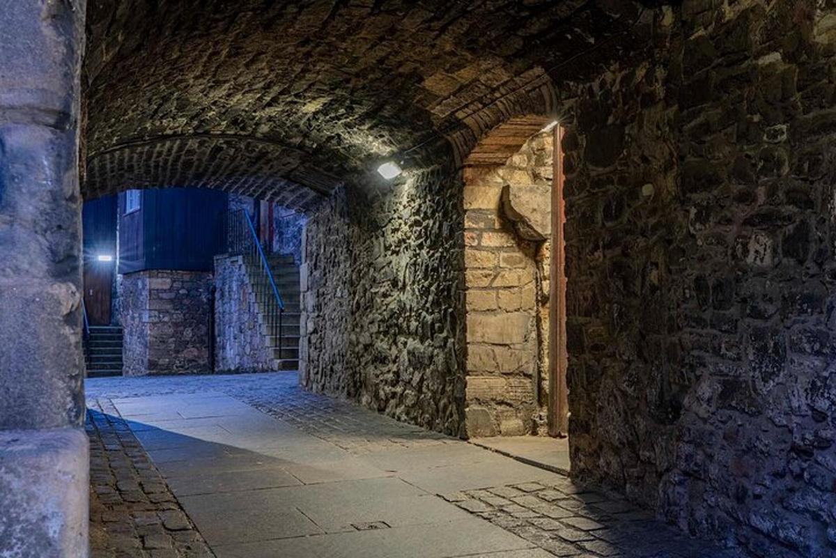 a stone hallway with an archway in a building