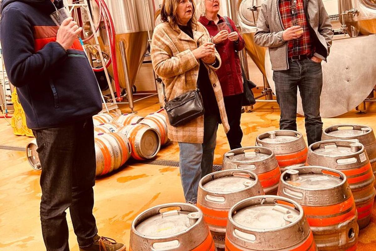 a group of people standing in a room with barrels