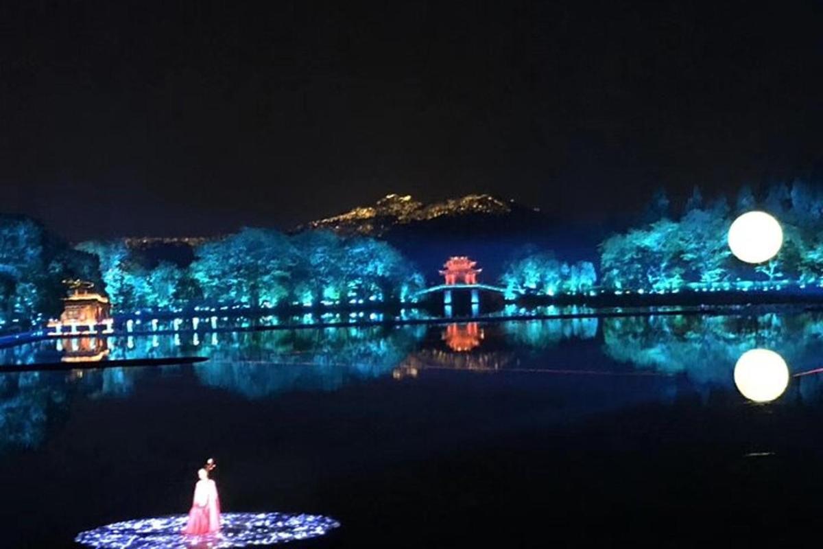 a woman in a dress standing in the water at night