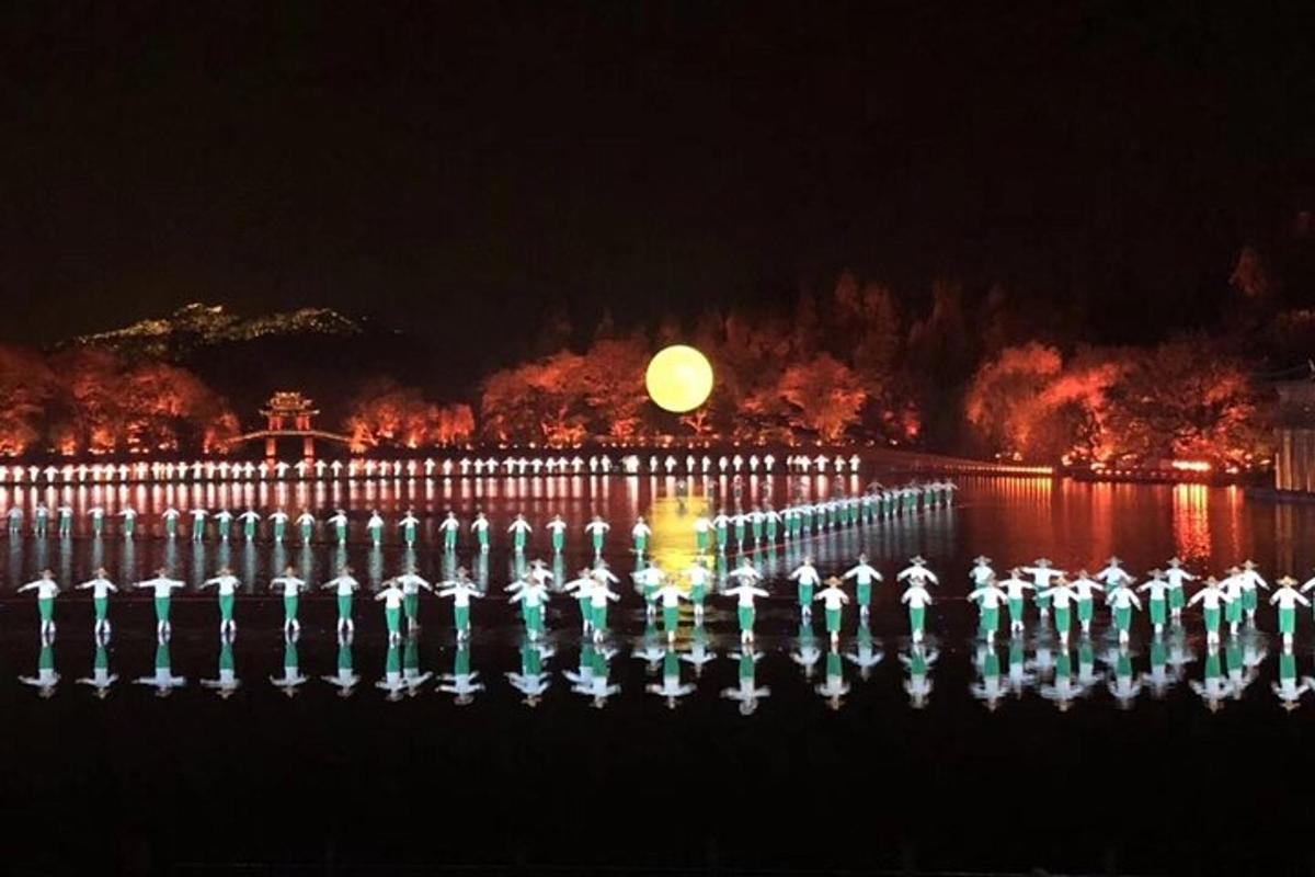 a fence with lights in the water at night