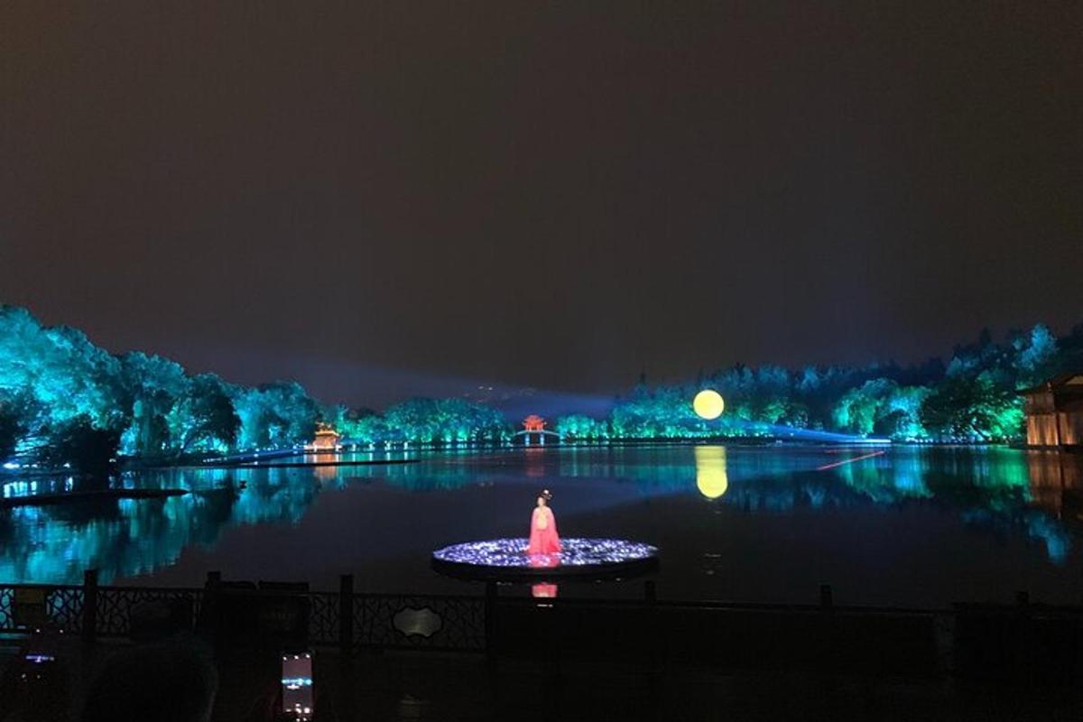 Un gran cuerpo de agua por la noche con un estanque iluminado.
