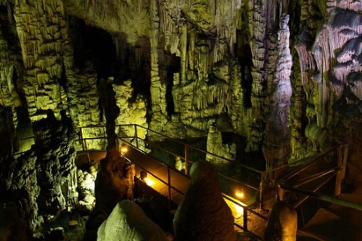 a tour of a cave with lights in it