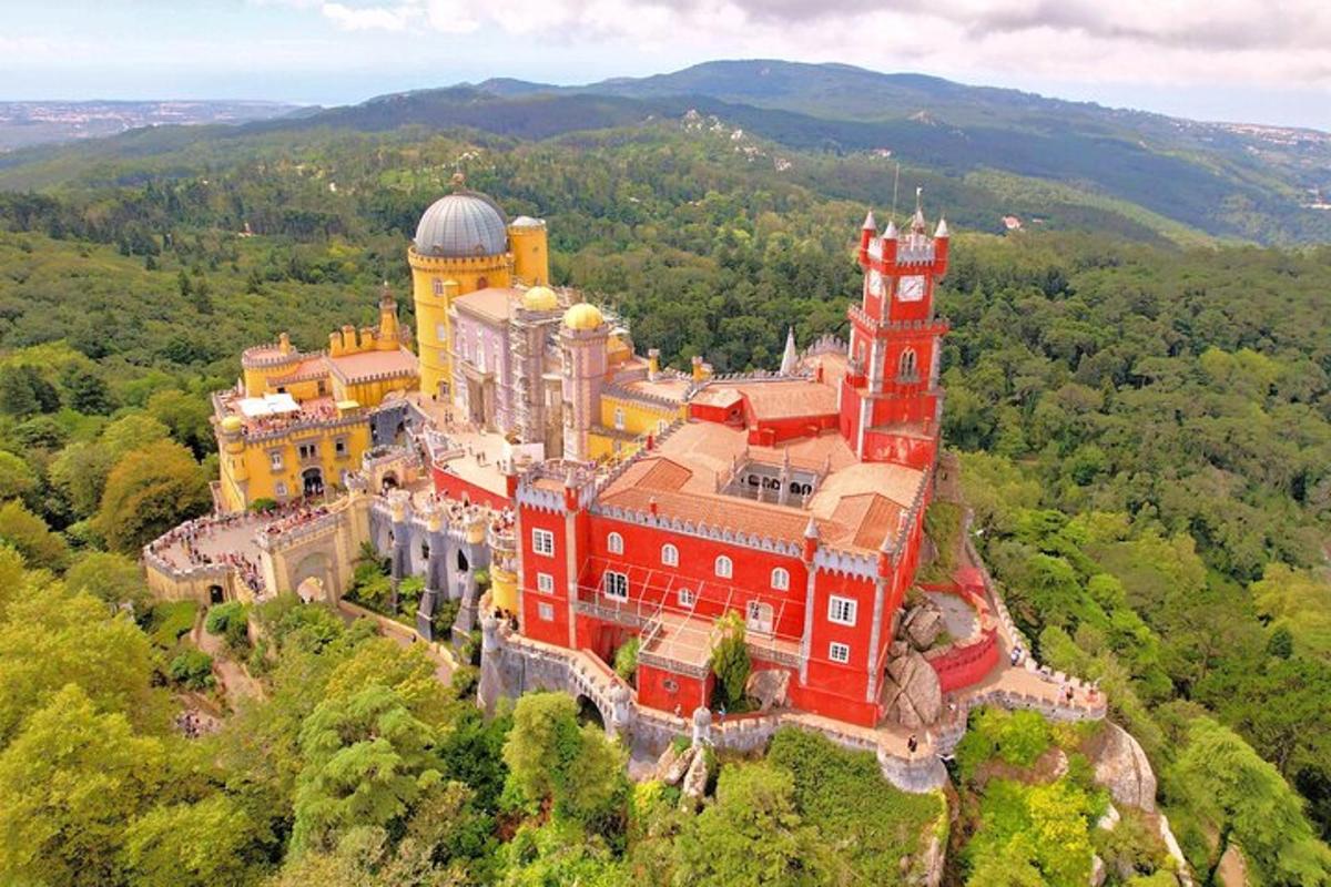 an aerial view of a large red building on a hill