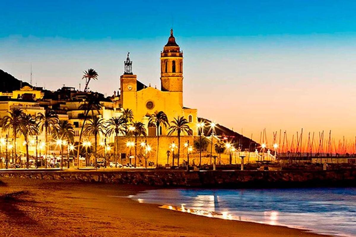 a large building with a clock tower on a beach