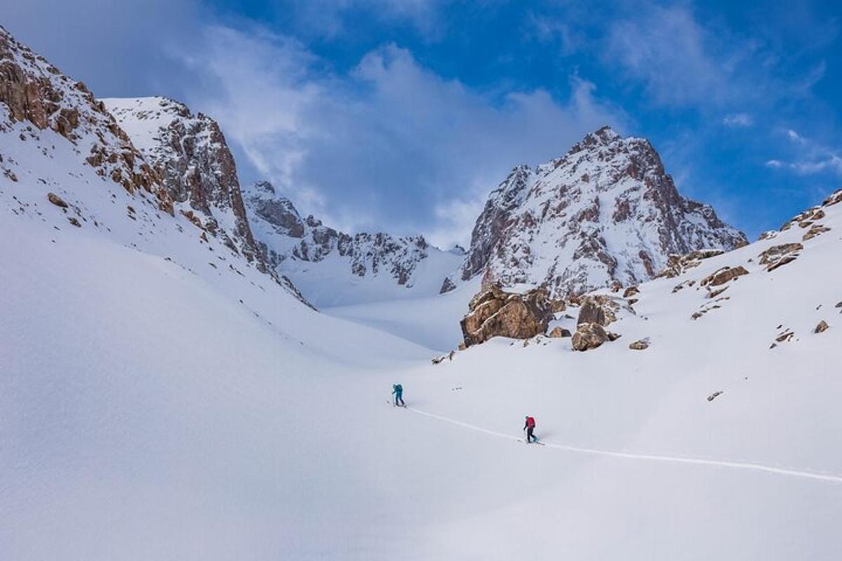 two people skiing down a snow covered mountain