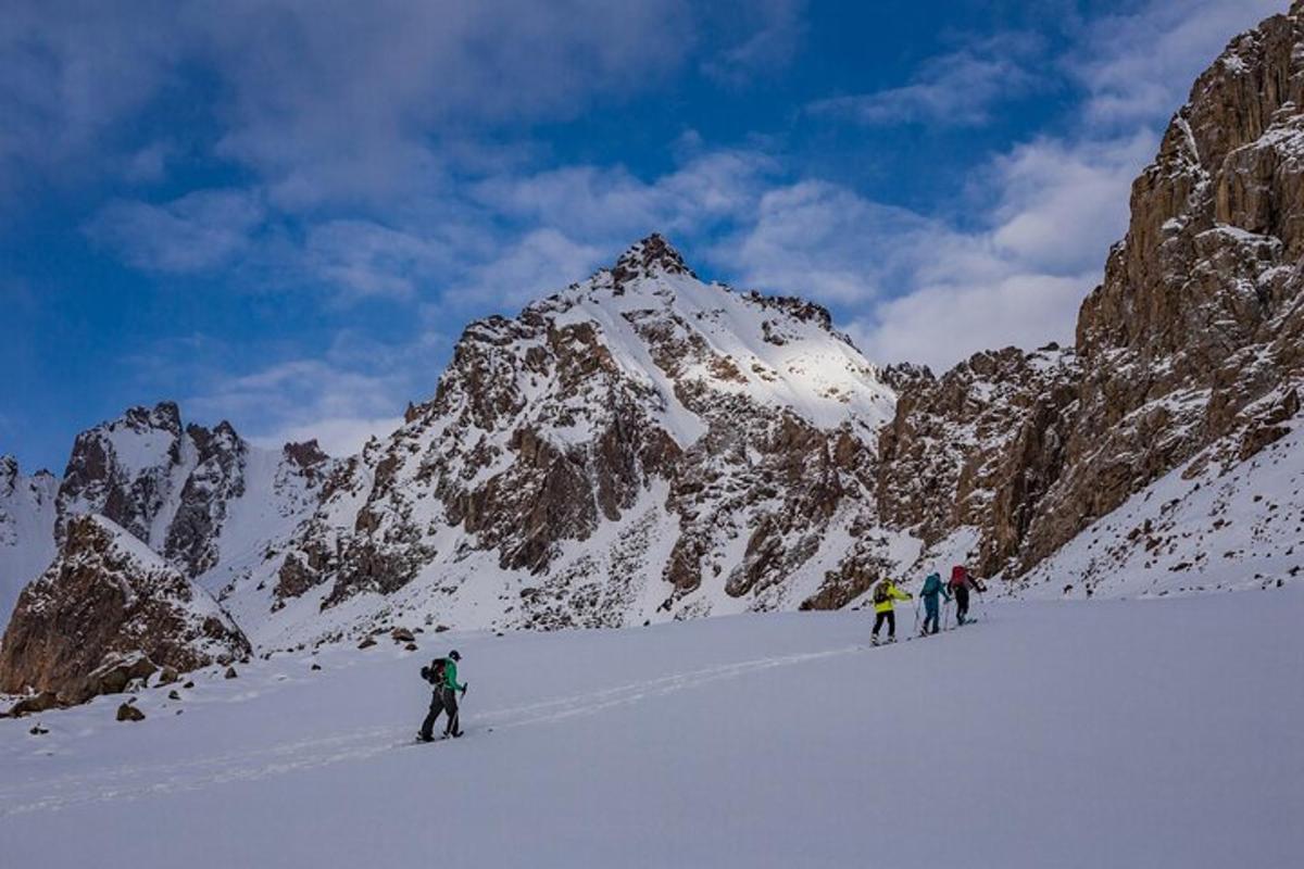 a group of people skiing on a snow covered mountain