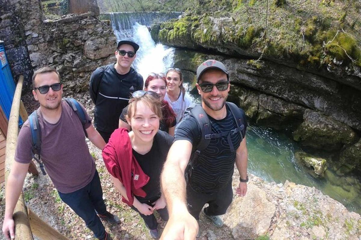 un gruppo di persone in posa davanti a una cascata
