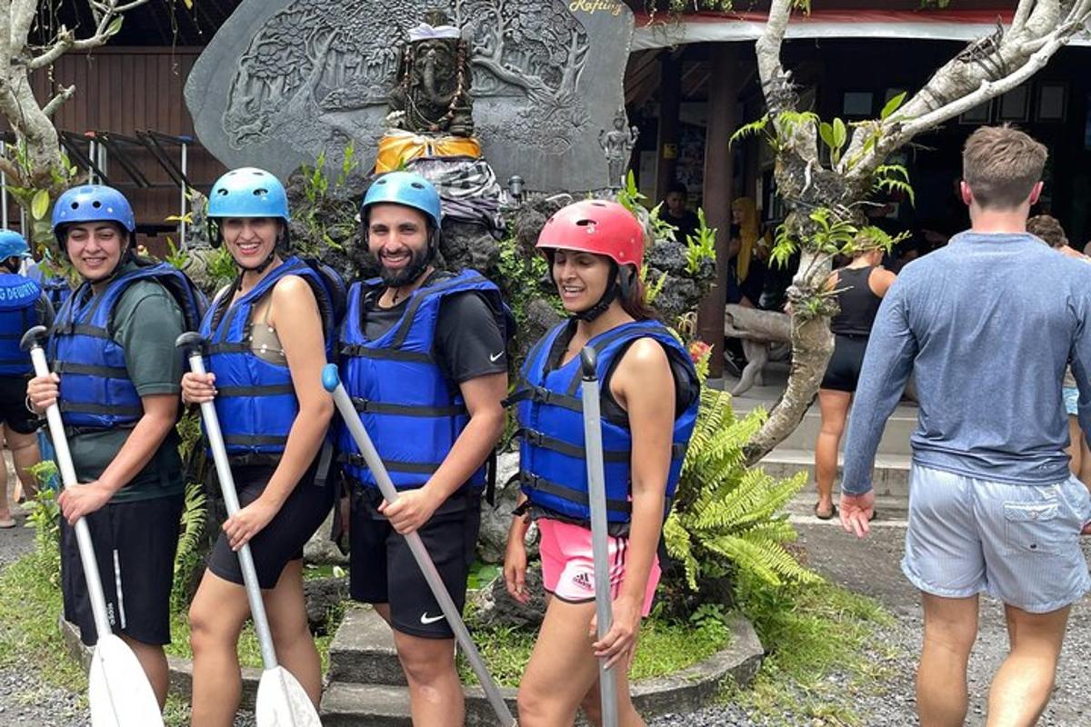 a group of people wearing helmets and holding paddles on a raft