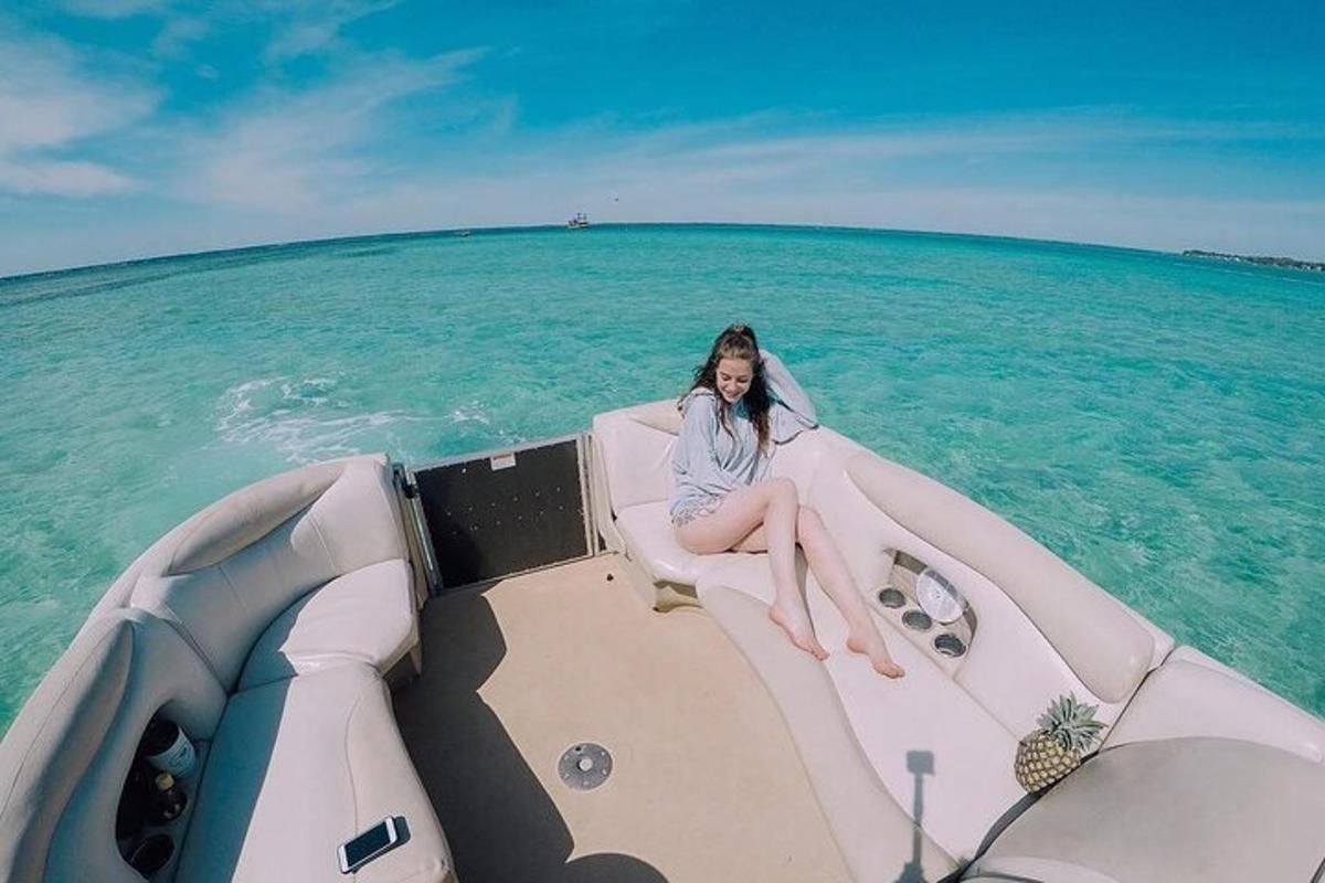 a woman sitting on the back of a boat in the ocean
