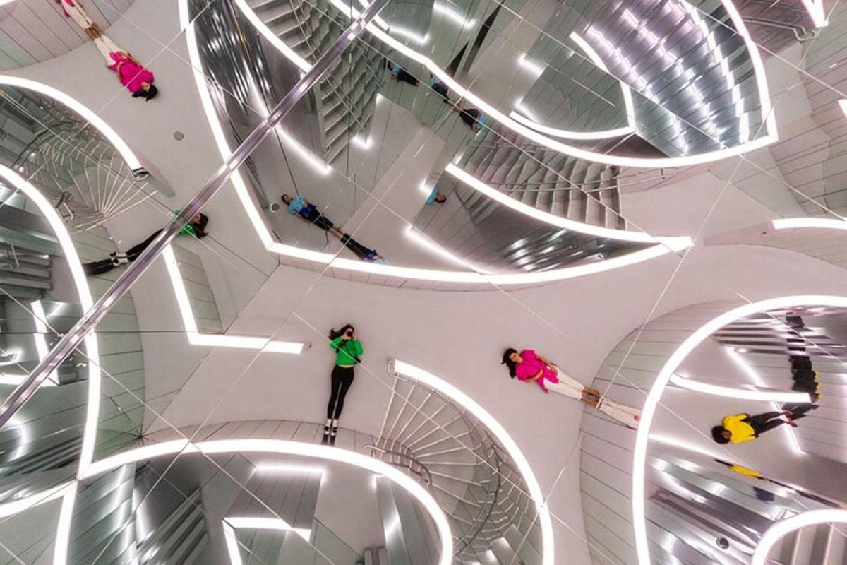 a person standing on a spiral staircase in a building