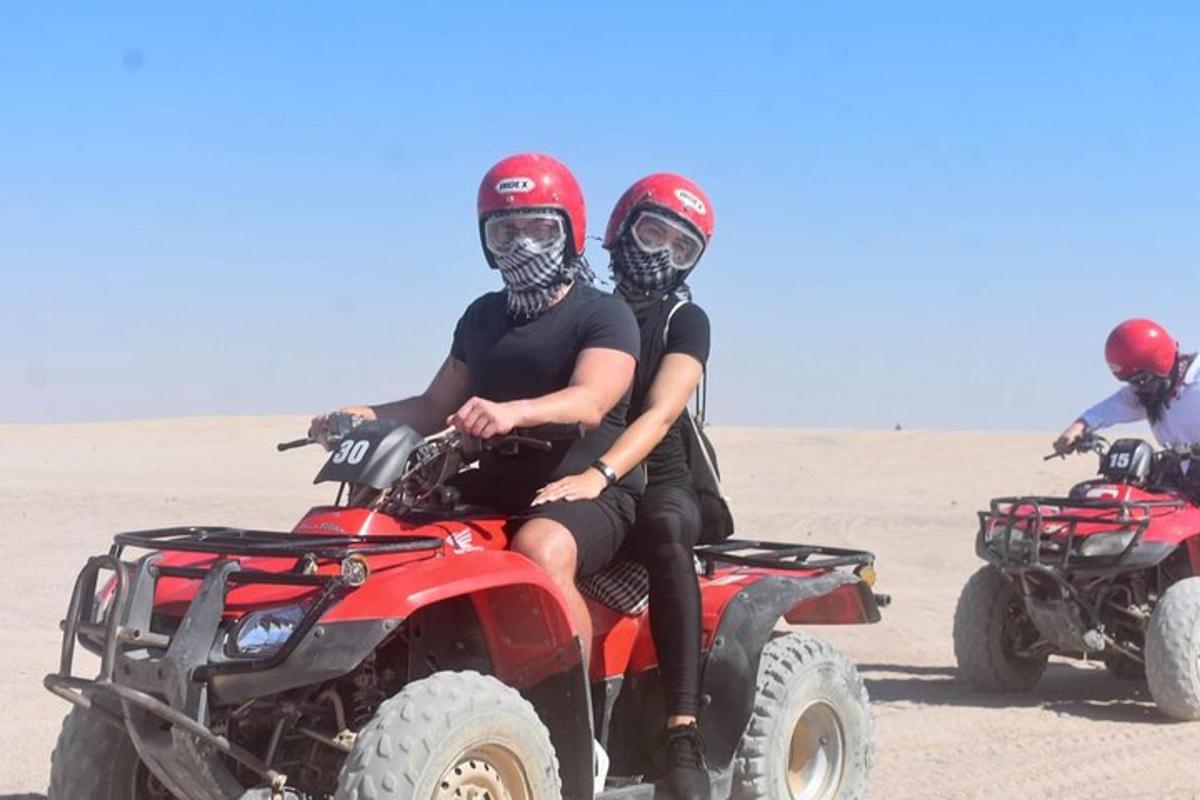 due persone sedute su quad nel deserto