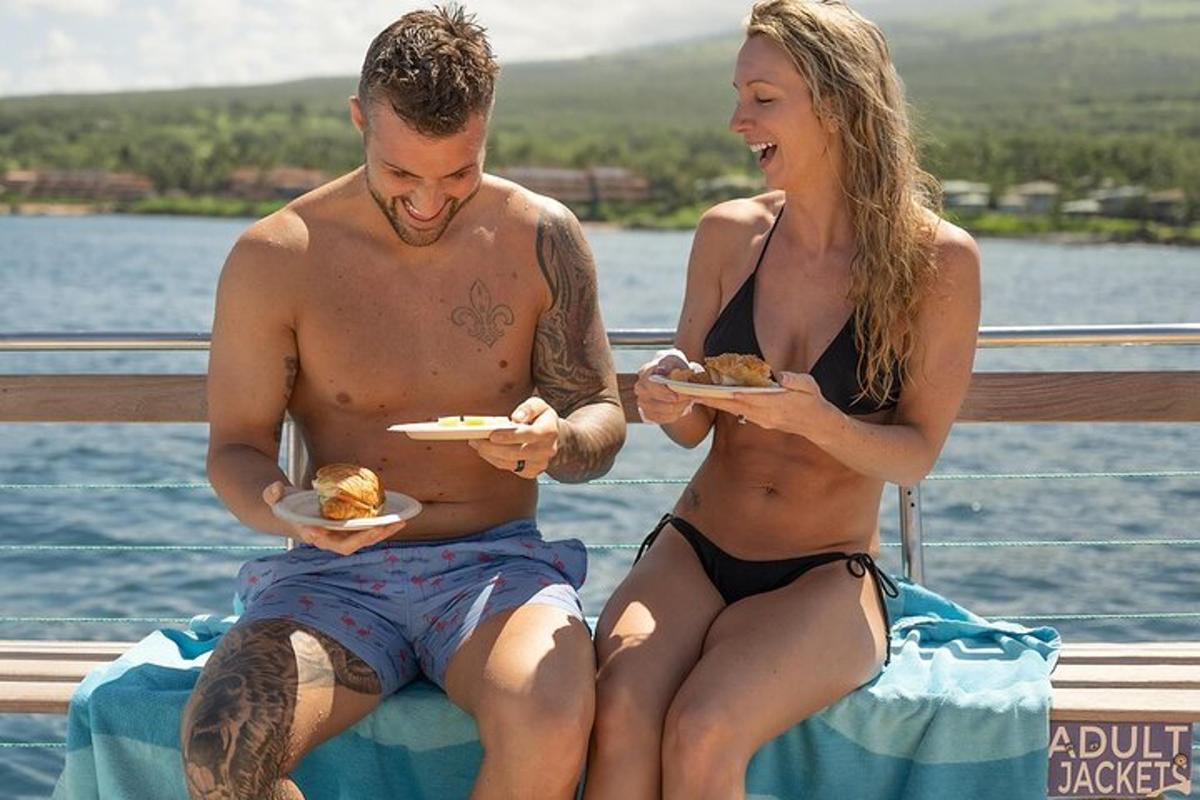 a man and a woman in bathing suits holding plates of food