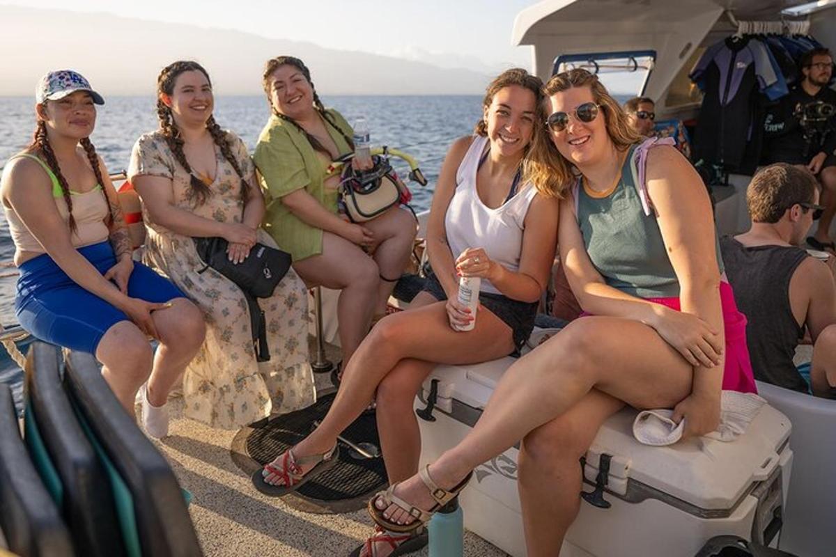 a group of women sitting on the back of a boat