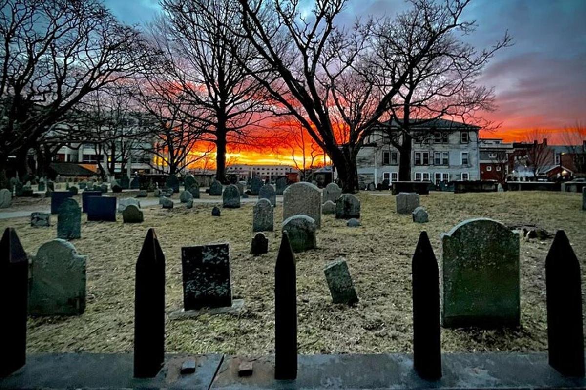 a cemetery with a sunset in the background