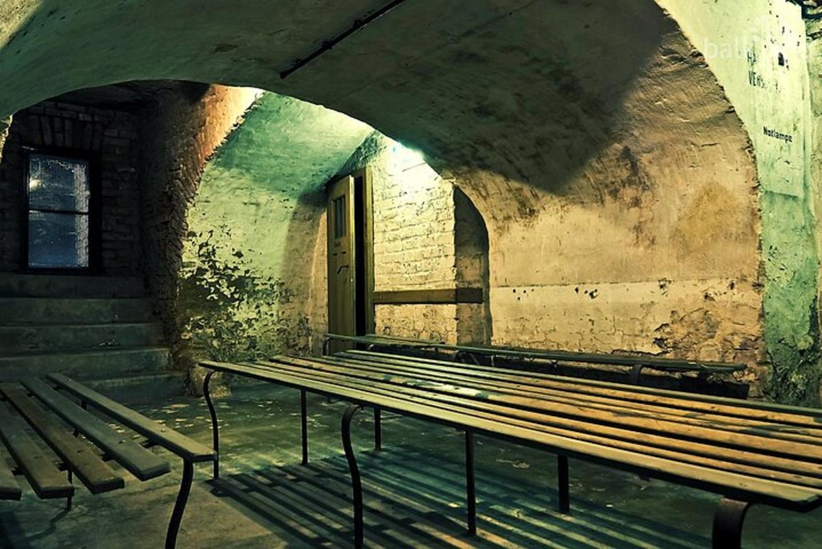 an empty bench in an old building with stairs