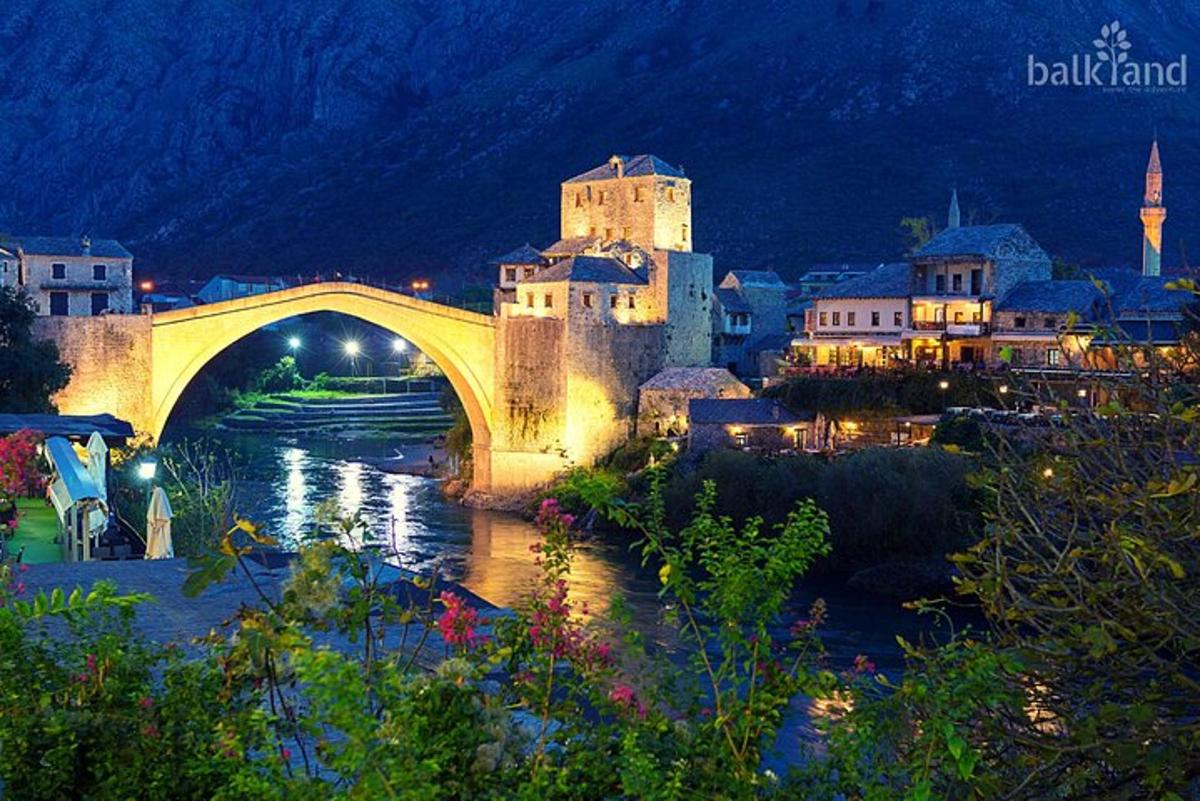a bridge over a river in a city at night