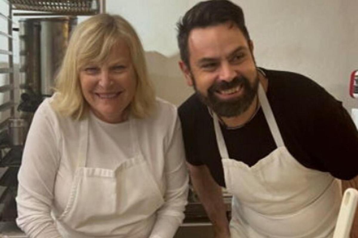 a man and a woman sitting in a kitchen