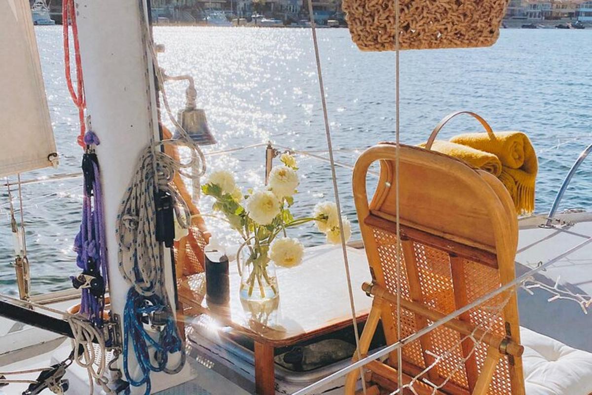 a table on a boat with a vase of flowers