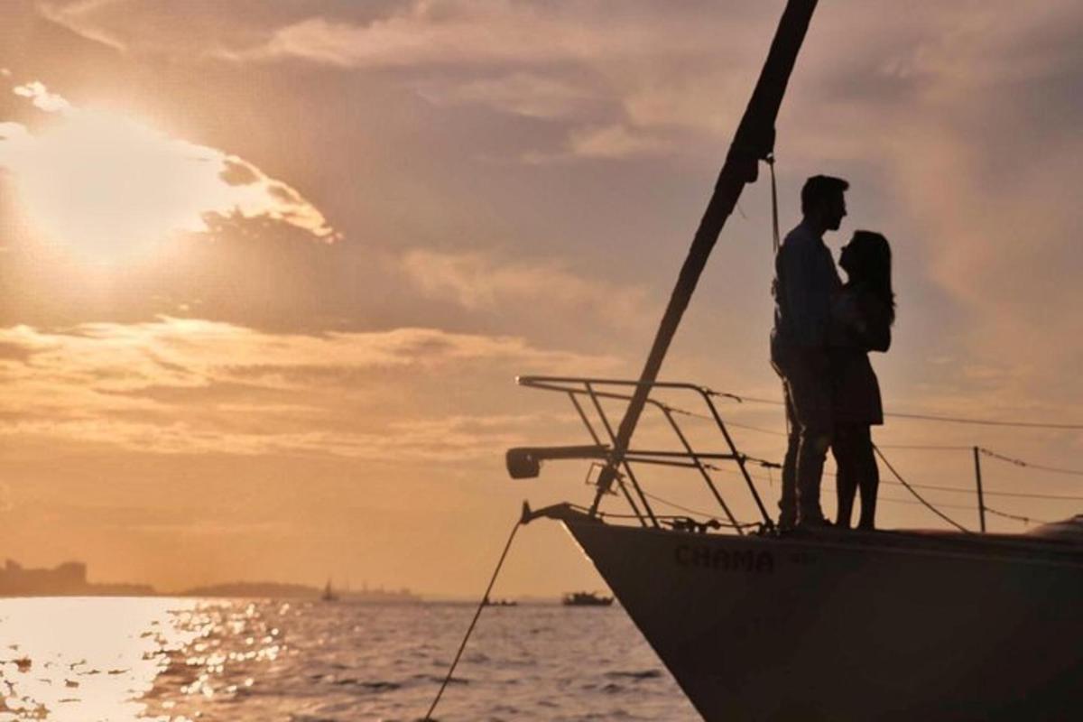 a man standing on the bow of a boat in the ocean