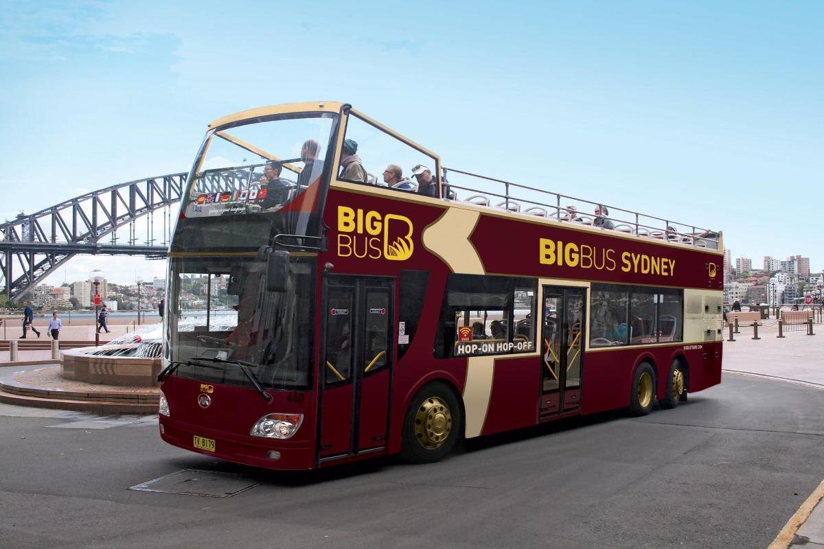 a red double decker bus driving down the street