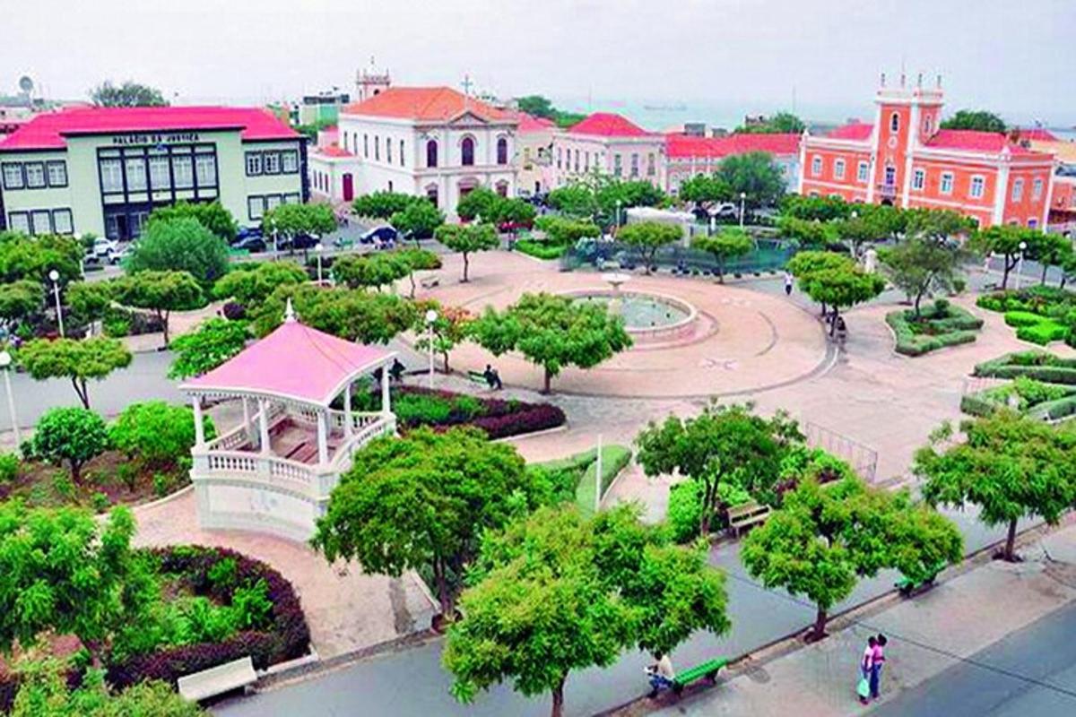a park with trees and buildings in a city
