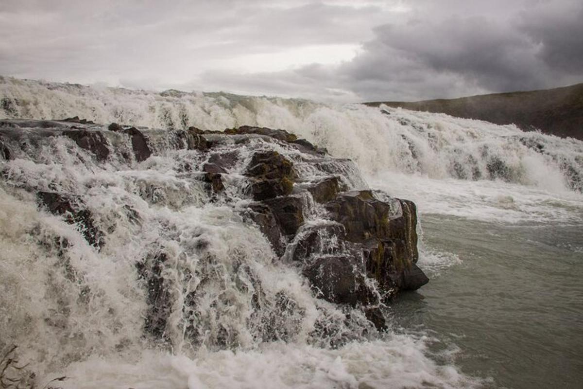 a waterfall in the middle of a body of water