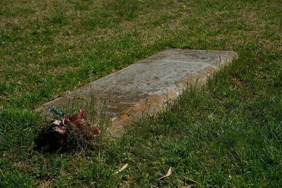 a stone slab in the grass in a field