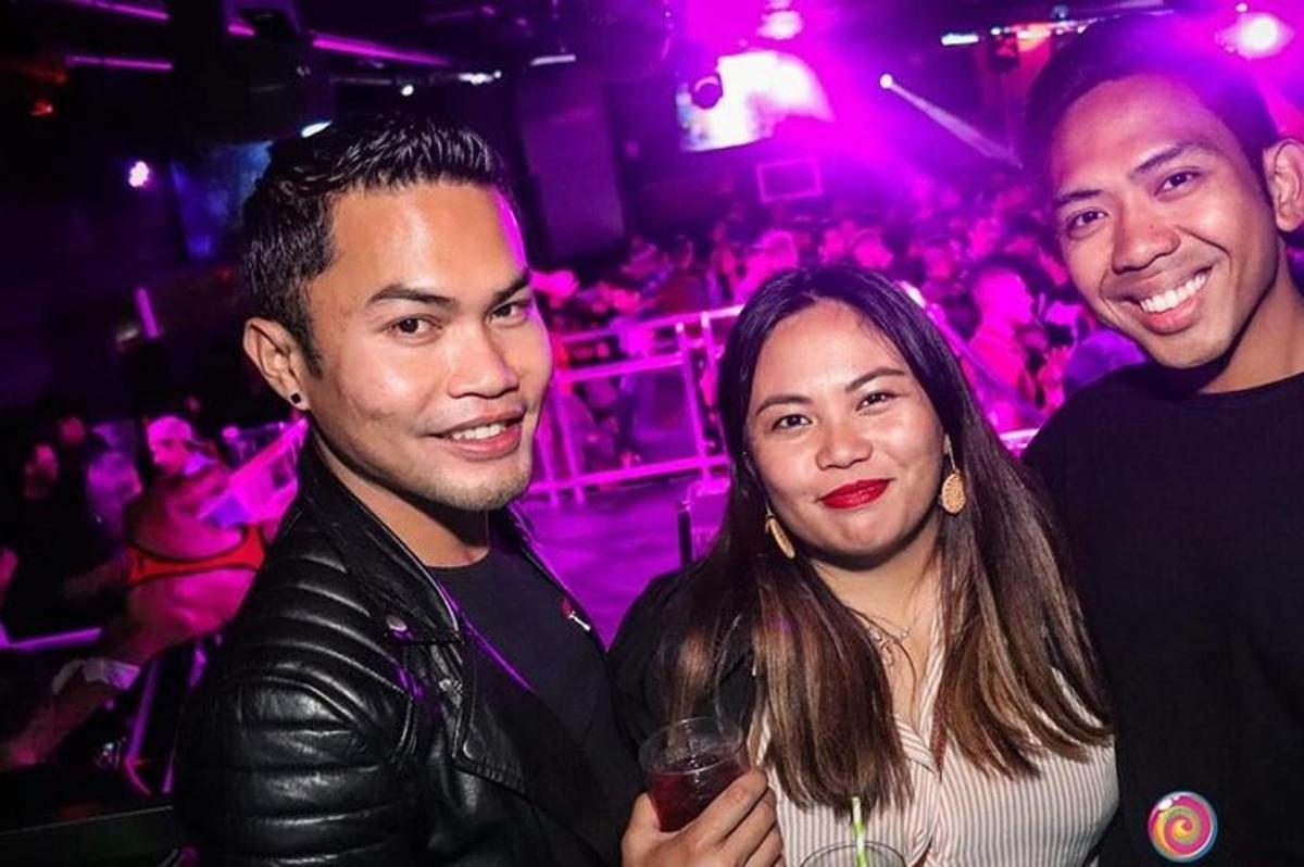 tre persone posano per una foto a una festa