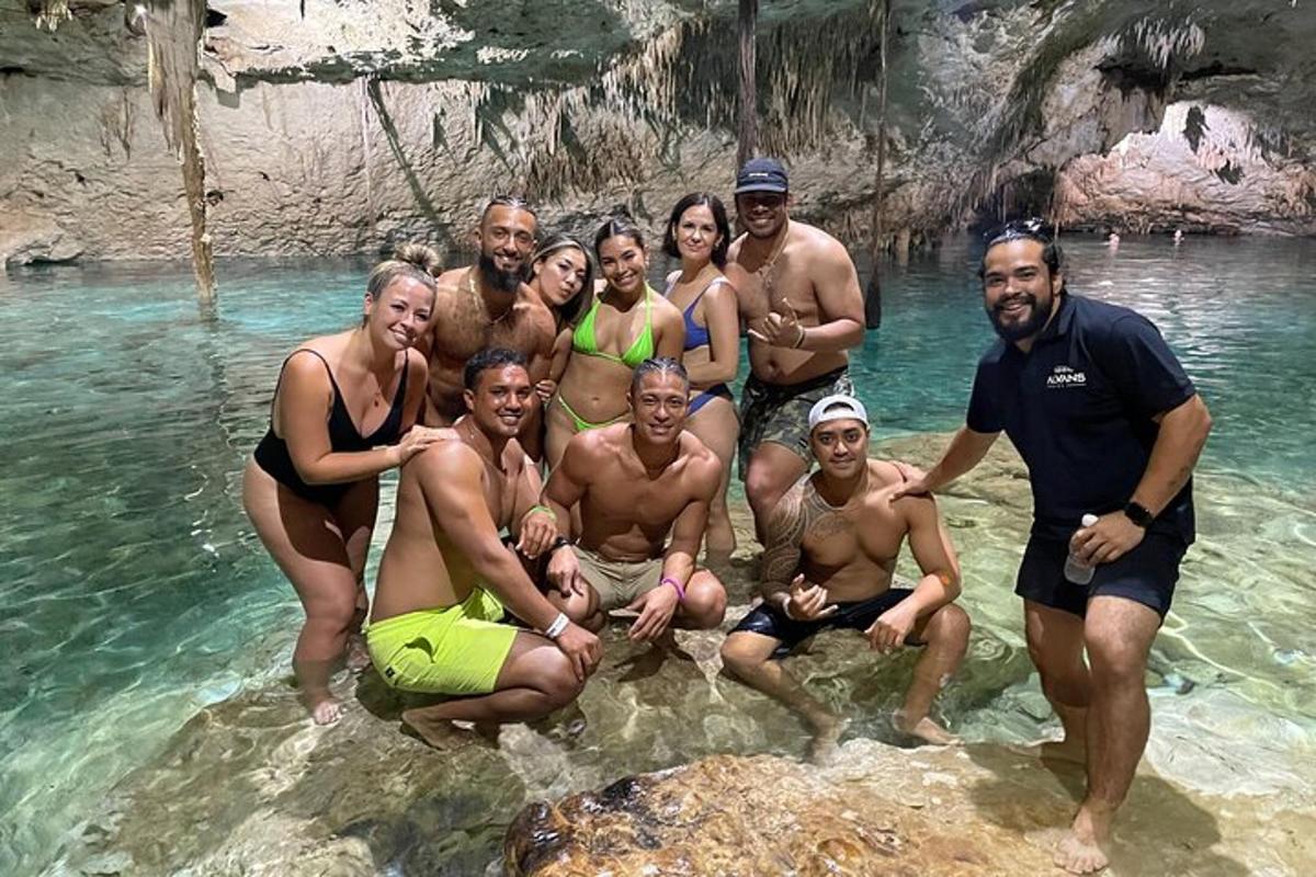 a group of people posing for a picture in the water