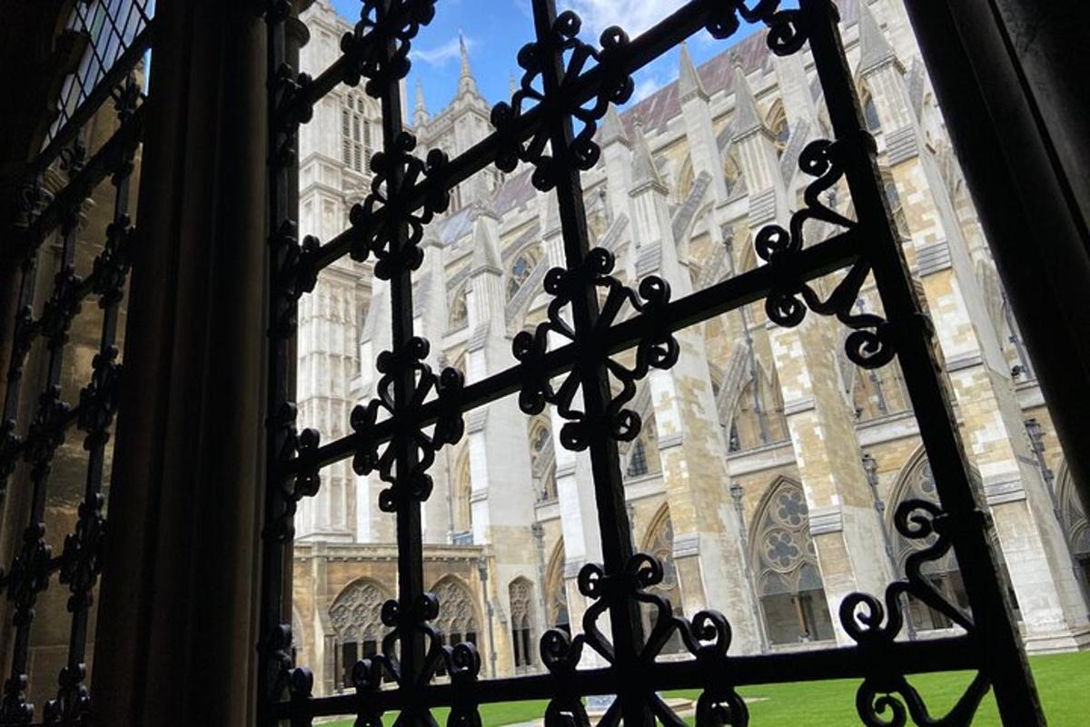 a view of a large building through a wrought iron gate