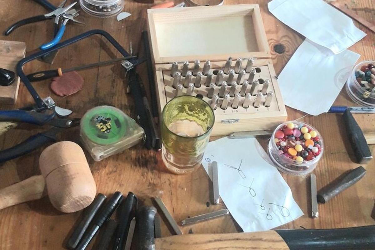 a desk with an old keyboard and a glass of beer