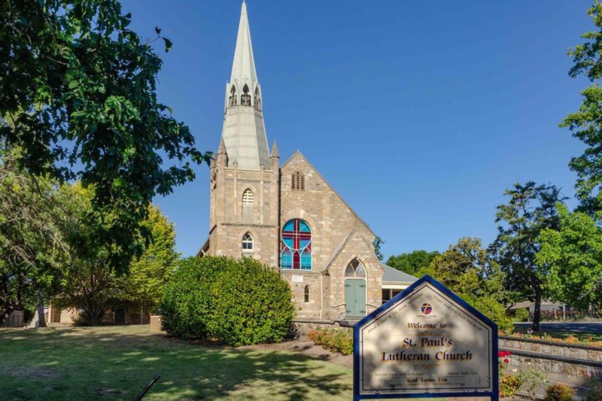 a church with a tower and a sign in front of it
